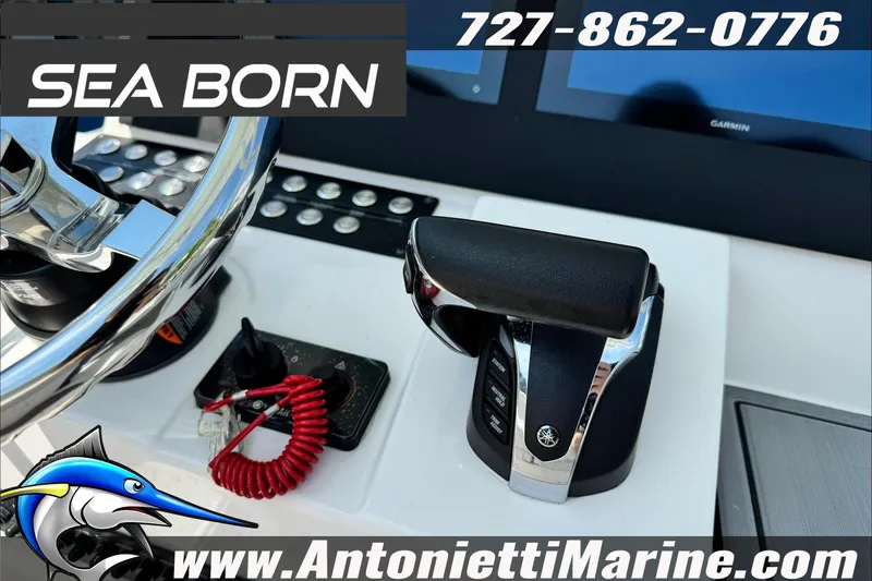 Slide: The Image of 2025 Sea Born LX24 Center Console boat controls with steering wheel and throttle. - 17