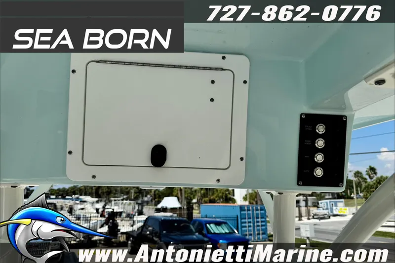 Slide: The Image of 2025 Sea Born LX24 Center Console boat dashboard with controls and storage compartment. - 21