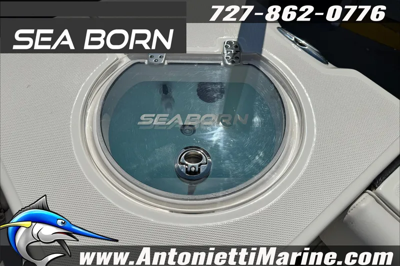 Slide: The Image of 2025 Sea Born LX24 Center Console boat livewell with logo and contact details. - 22
