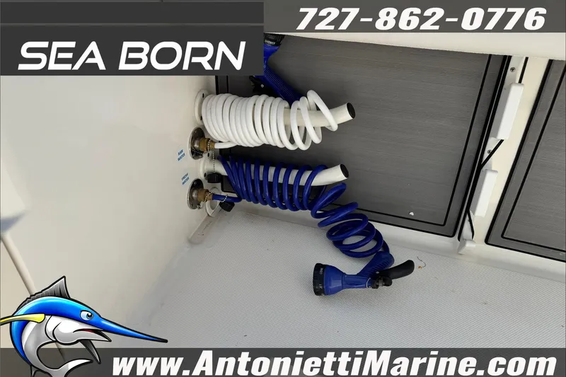 Slide: The Image of 2025 Sea Born LX24 Center Console boat with coiled hoses and storage compartments. - 25