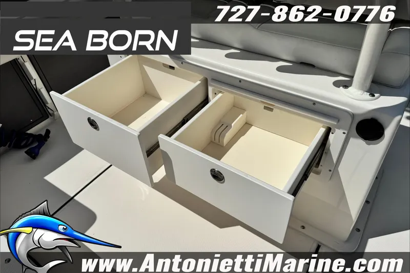 Slide: The Image of 2025 Sea Born LX24 Center Console boat storage compartments, featuring open drawers. - 27