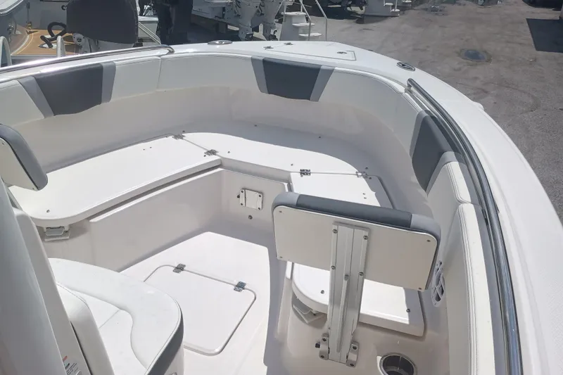 Slide: The Image of 2025 Robalo R230 Center Console boat interior with seating and storage compartments. - 19