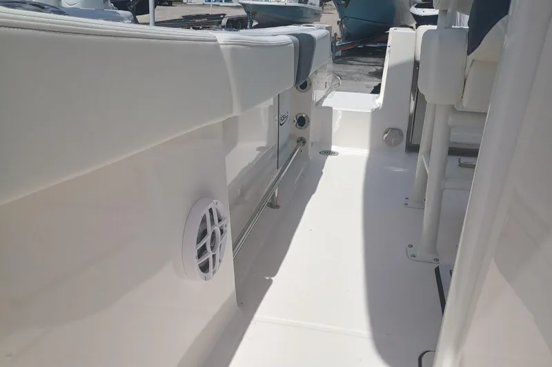 Slide: The Image of 2025 Robalo R230 Center Console boat interior, featuring white seating and sleek design elements. - 30