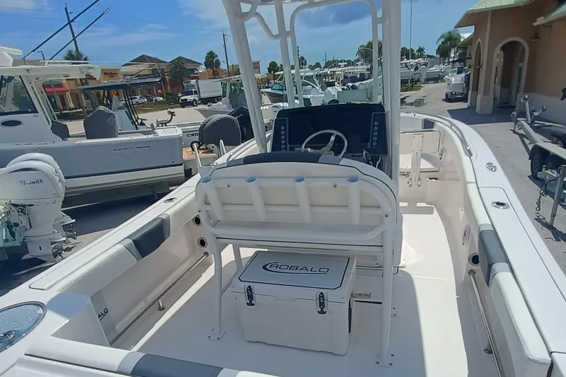 Slide: The Image of 2025 Robalo R230 Center Console boat interior with steering console and seating. - 7