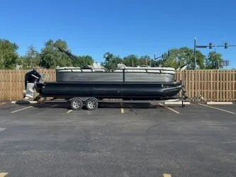 Slide: The Image of 2024 Regency 250 LE3 pontoon boat on trailer in parking lot. - 4