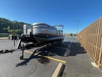 Slide: The Image of 2024 Regency 250 LE3 pontoon boat on trailer in parking lot. - 5