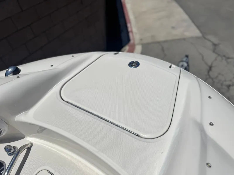 Slide: The Image of 2005 Sea Ray 240 Sundeck boat deck with storage compartment. - 12