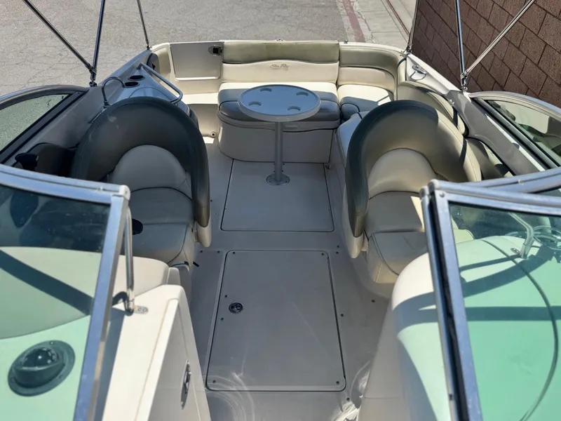 Slide: The Image of 2005 Sea Ray 240 Sundeck interior with seating and table, showcasing spacious design. - 14