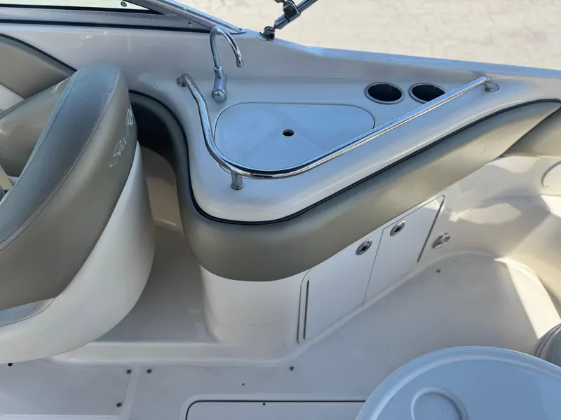 Slide: The Image of 2005 Sea Ray 240 Sundeck interior with sink and cup holders. - 18