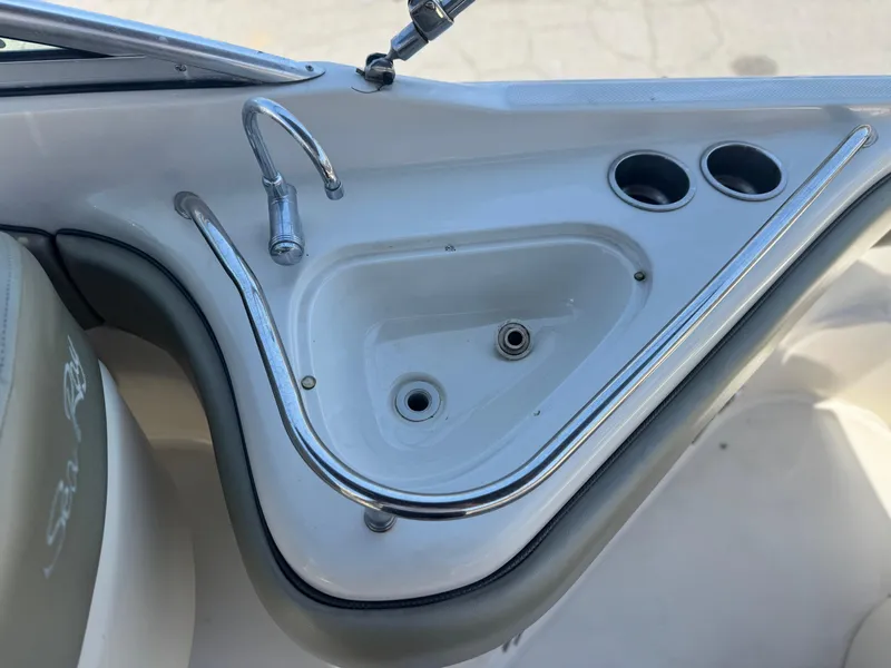 Slide: The Image of 2005 Sea Ray 240 Sundeck boat sink and cup holders. - 19
