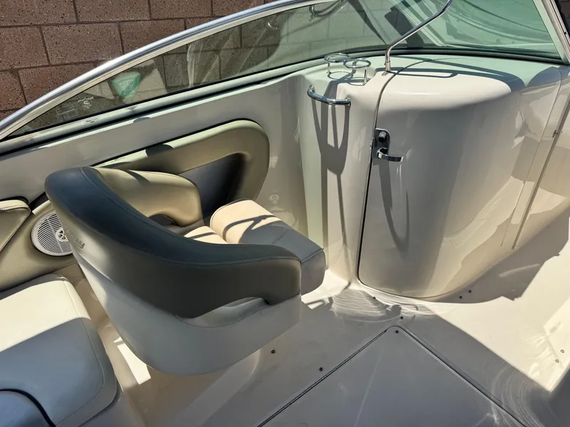 Slide: The Image of 2005 Sea Ray 240 Sundeck interior with seating and steering wheel. - 23