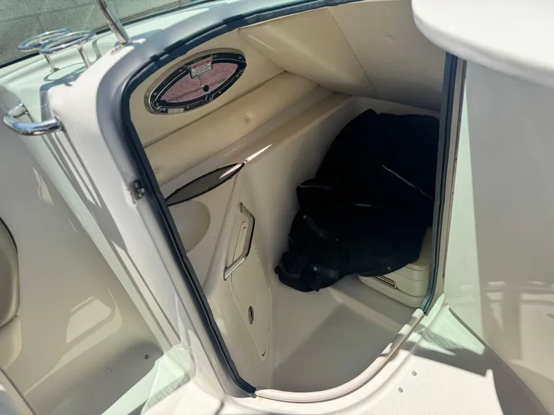 Slide: The Image of Interior cabin of 2005 Sea Ray 240 Sundeck boat, showing storage space. - 24