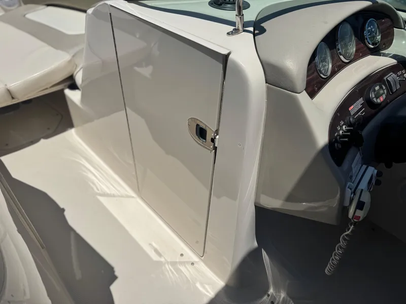 Slide: The Image of 2005 Sea Ray 240 Sundeck interior with dashboard and seating area. - 28