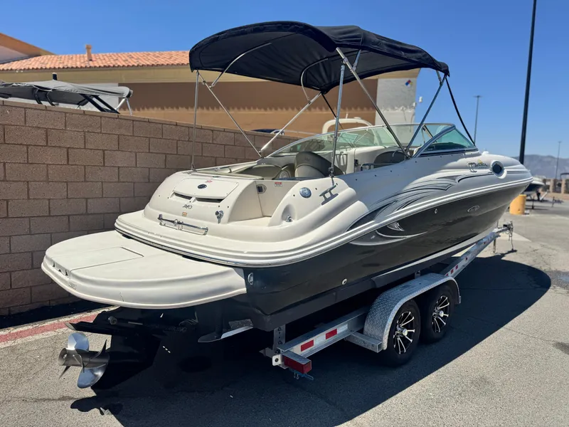 Slide: The Image of 2005 Sea Ray 240 Sundeck boat on trailer, featuring sleek design and black canopy. - 5