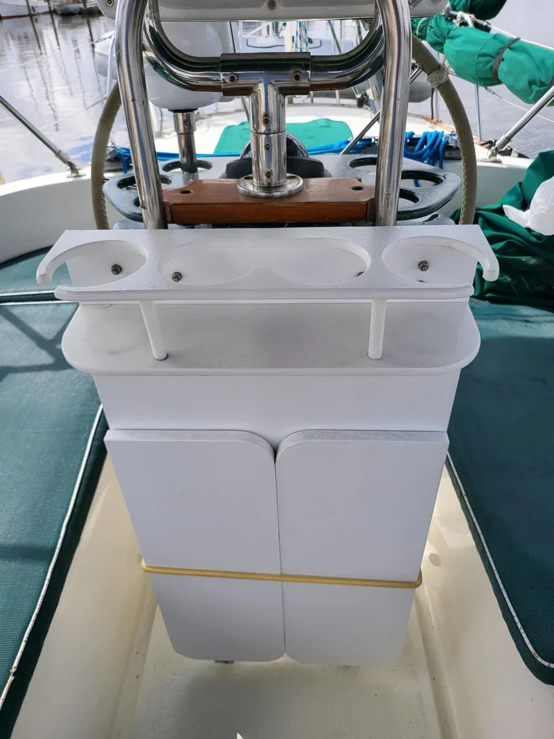 Slide: The Image of Cockpit of 1983 Irwin 38 Center Cockpit sailboat with steering wheel and storage compartments. - 11
