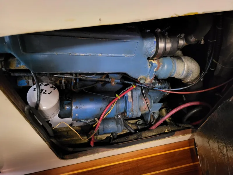 Slide: The Image of Engine compartment of a 1983 Irwin 38 Center Cockpit sailboat, showing blue machinery and wiring. - 18