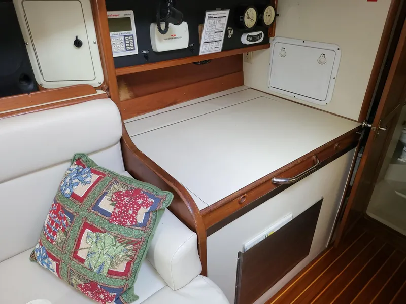 Slide: The Image of Interior of 1983 Irwin 38 Center Cockpit with navigation equipment and decorative pillow. - 19