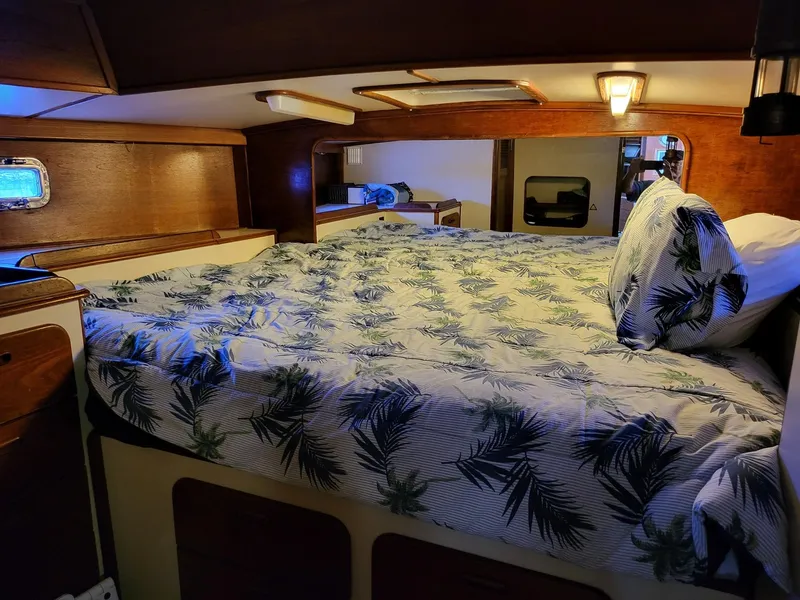 Slide: The Image of Cozy cabin interior of 1983 Irwin 38 Center Cockpit with tropical bedding. - 24