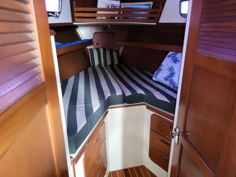 Slide: The Image of Cozy cabin interior of 1983 Irwin 38 Center Cockpit sailboat with striped bedding. - 27