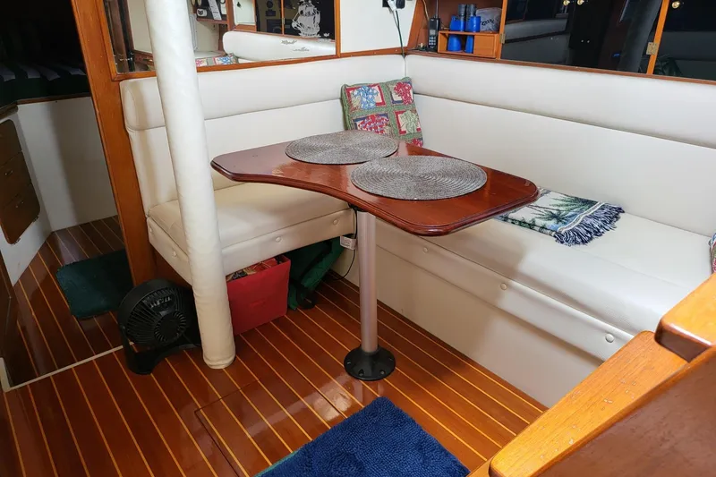Slide: The Image of Interior of 1983 Irwin 38 Center Cockpit with cozy seating and wooden table. - 29