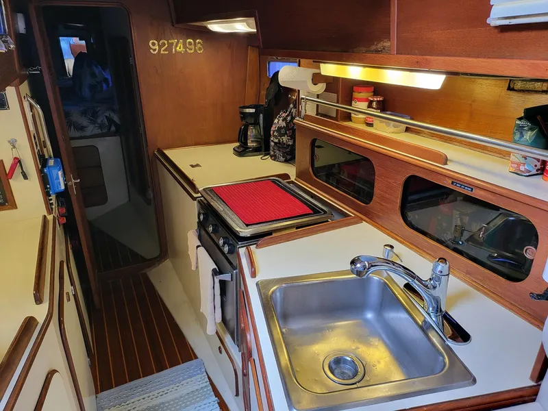 Slide: The Image of 1983 Irwin 38 Center Cockpit yacht interior with kitchen sink and stove. - 3