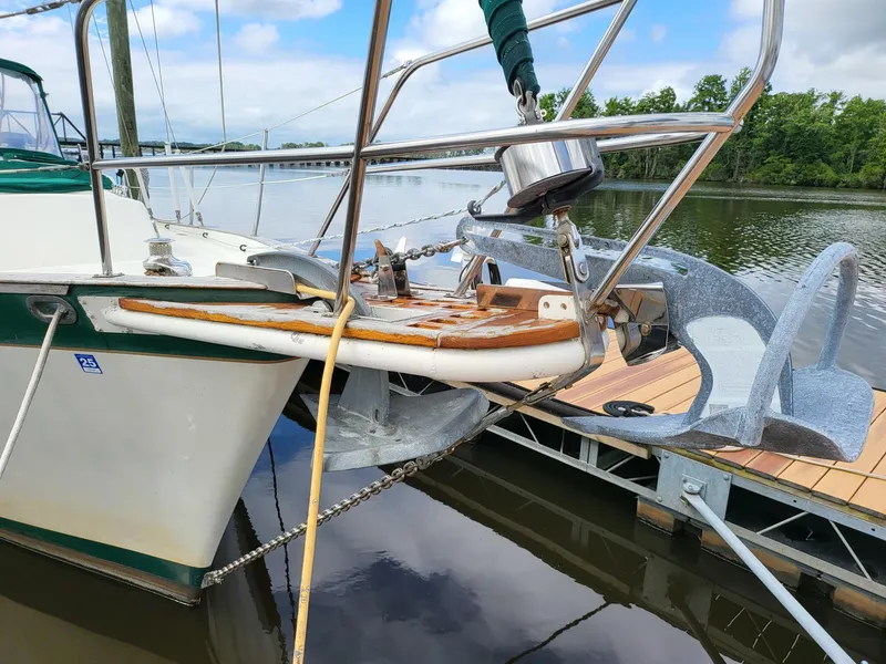 Slide: The Image of 1983 Irwin 38 Center Cockpit sailboat docked, featuring anchor and bow details. - 30