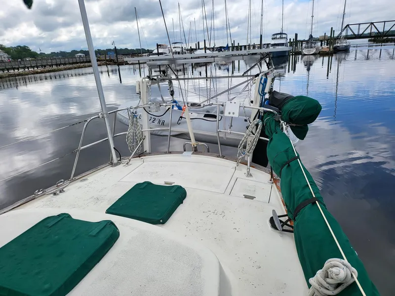 Slide: The Image of 1983 Irwin 38 Center Cockpit sailboat docked in a calm marina. - 32