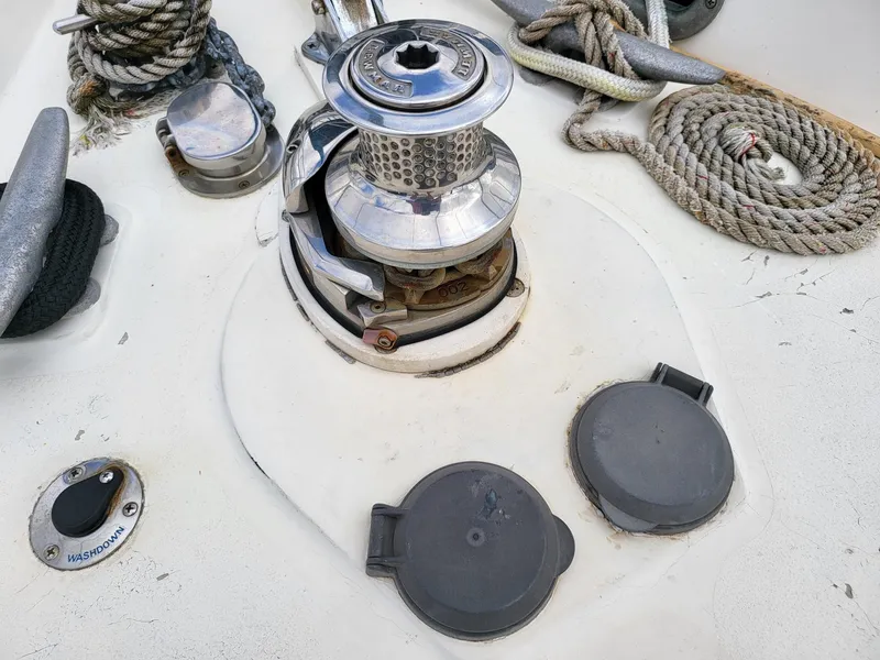 Slide: The Image of Deck of 1983 Irwin 38 Center Cockpit with winch, ropes, and cleats. - 33