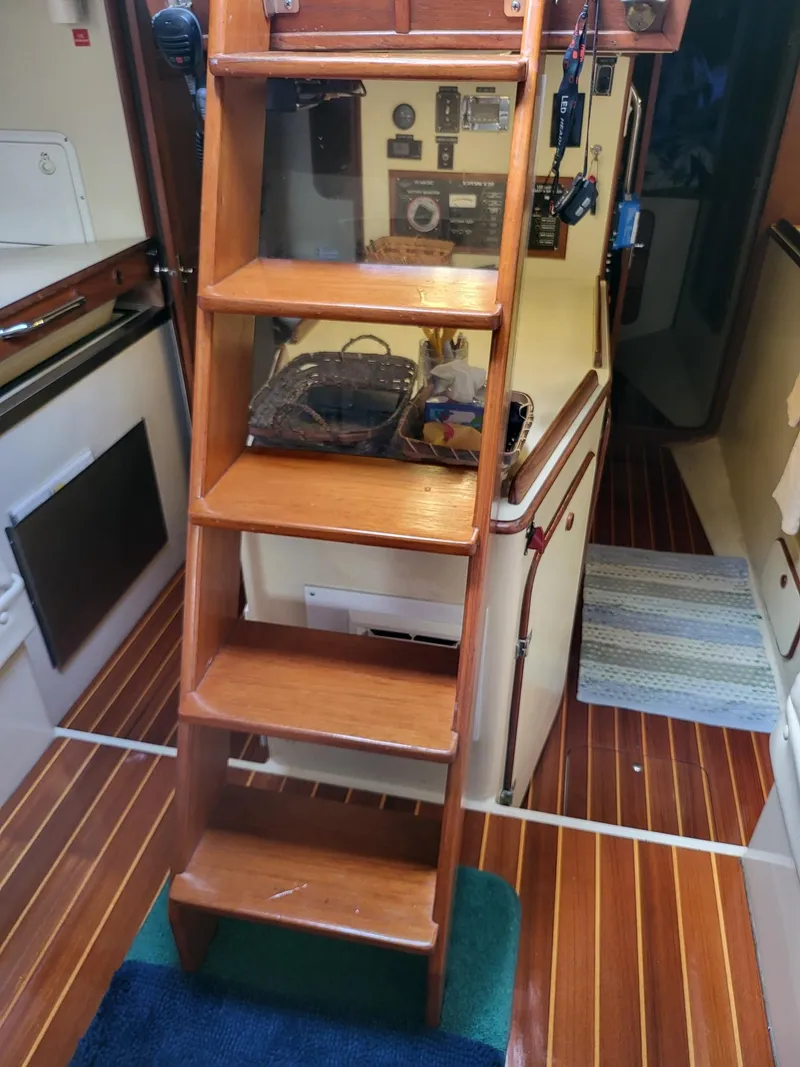 Slide: The Image of 1983 Irwin 38 Center Cockpit interior with wooden steps and nautical equipment. - 8