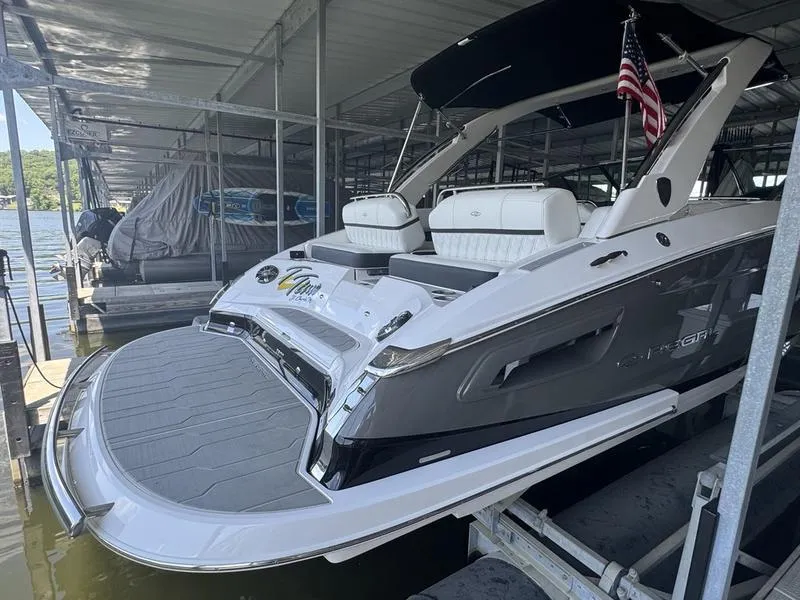 Slide: The Image of 2019 Regal 2800 boat docked, featuring sleek design and American flag. - 3