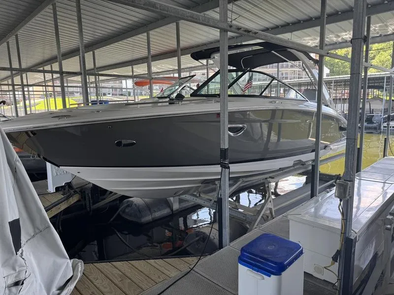 Slide: The Image of 2019 Regal 2800 boat docked in a covered marina. - 6