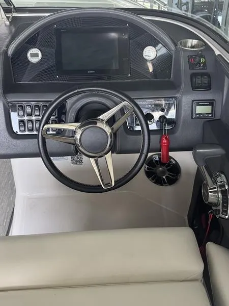 Slide: The Image of Cockpit of 2019 Regal 2800 boat with steering wheel and control panel. - 8