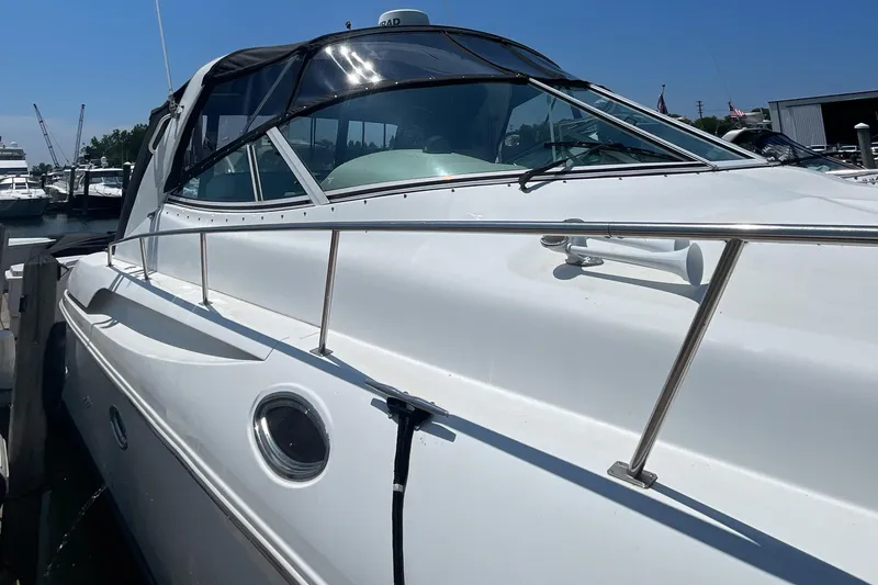 Slide: The Image of 2000 Cruisers Yachts 3870 Express docked at marina, side view. - 12