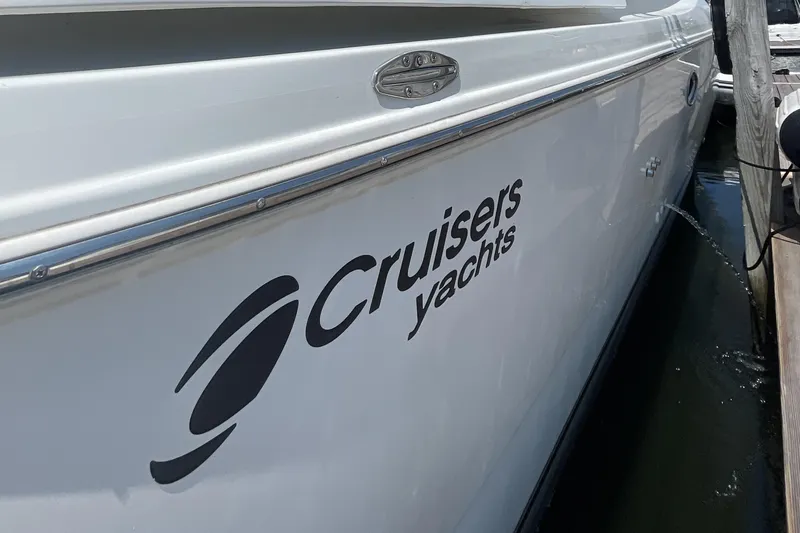 Slide: The Image of 2000 Cruisers Yachts 3870 Express docked, showcasing sleek design and branding. - 13