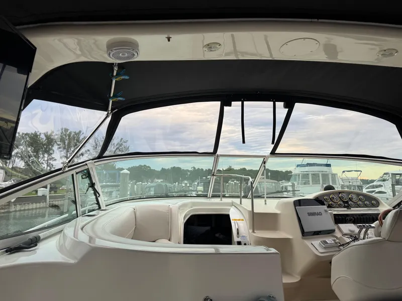 Slide: The Image of 2000 Cruisers Yachts 3870 Express helm with modern navigation equipment and marina view. - 14