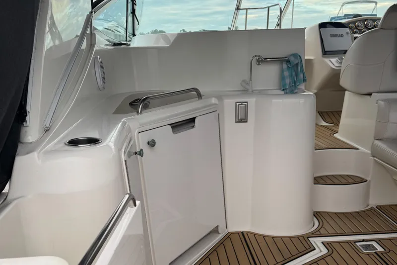 Slide: The Image of 2000 Cruisers Yachts 3870 Express interior with sink, seating, and wooden flooring. - 16