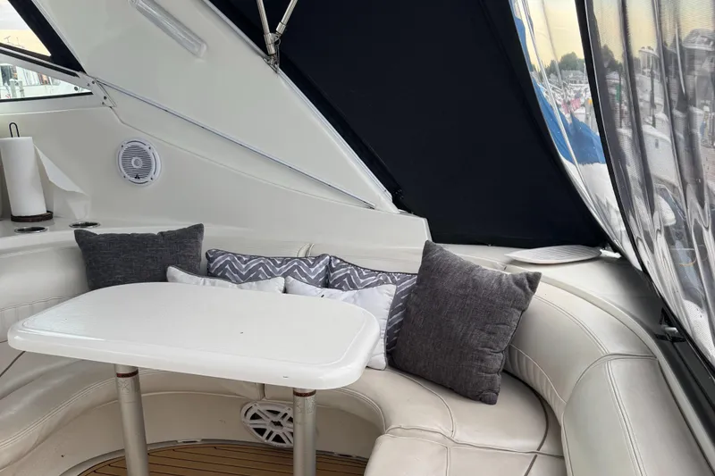 Slide: The Image of Interior of 2000 Cruisers Yachts 3870 Express with cushioned seating and table. - 18