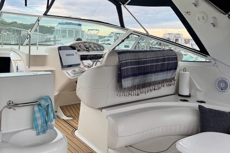 Slide: The Image of 2000 Cruisers Yachts 3870 Express cockpit with helm, seating, and nautical decor. - 19