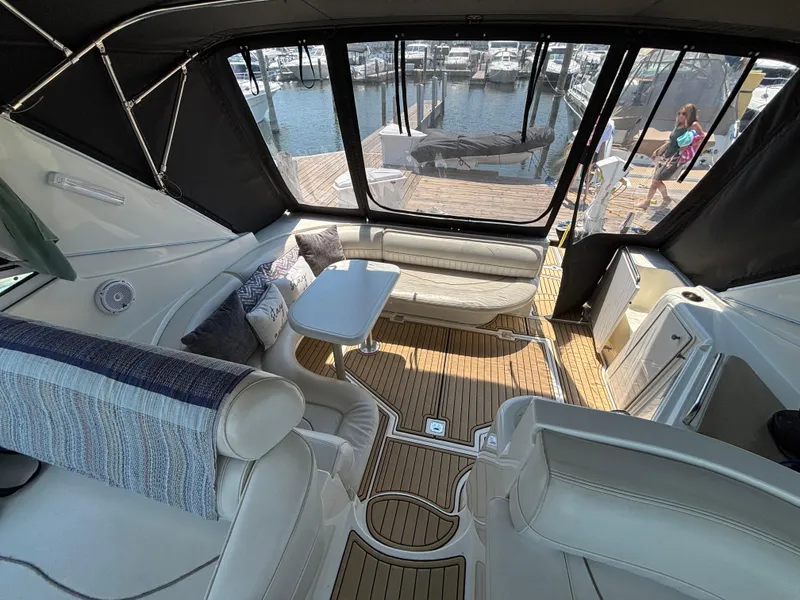 Slide: The Image of Interior of 2000 Cruisers Yachts 3870 Express with seating and table, dockside view. - 23