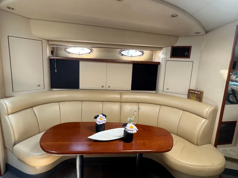 Slide: The Image of Luxurious interior of 2000 Cruisers Yachts 3870 Express with elegant seating and table. - 26
