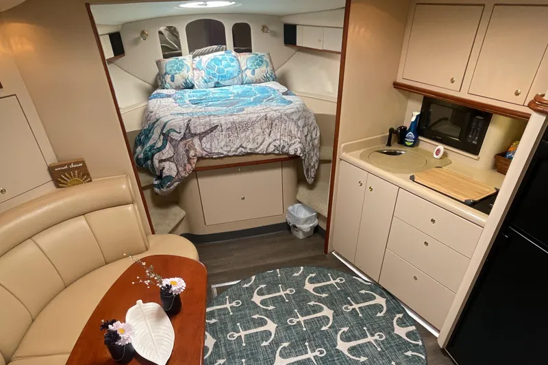 Slide: The Image of Interior of 2000 Cruisers Yachts 3870 Express with cozy bed and kitchenette. - 34