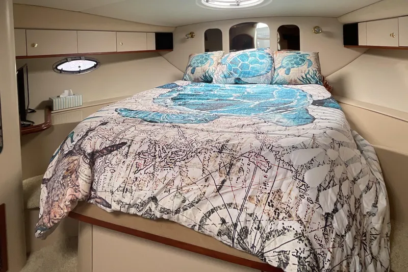 Slide: The Image of Cozy bedroom in 2000 Cruisers Yachts 3870 Express with turtle-themed bedding. - 38