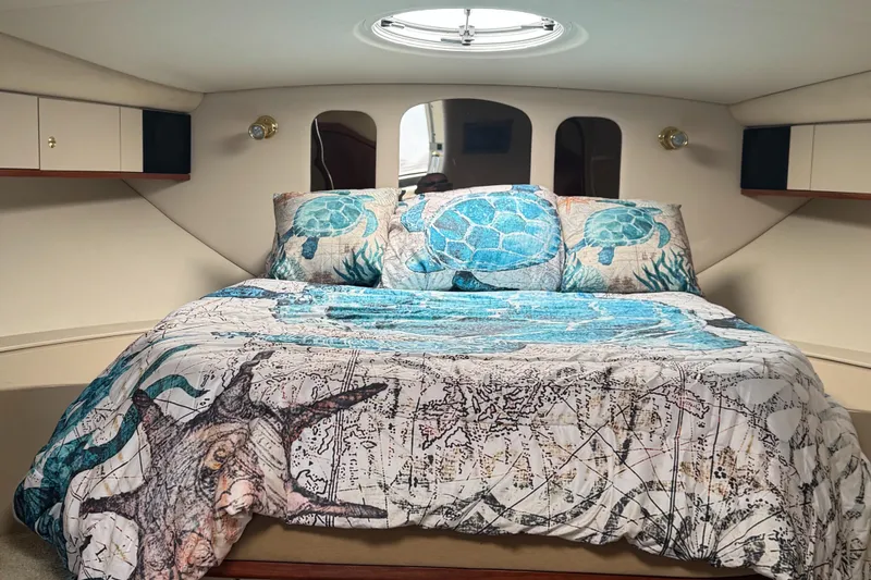 Slide: The Image of Luxurious cabin interior of 2000 Cruisers Yachts 3870 Express with nautical-themed bedding. - 39