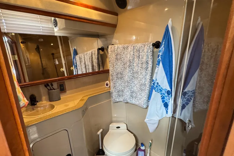 Slide: The Image of Bathroom interior of 2000 Cruisers Yachts 3870 Express with sink, mirror, and towels. - 42