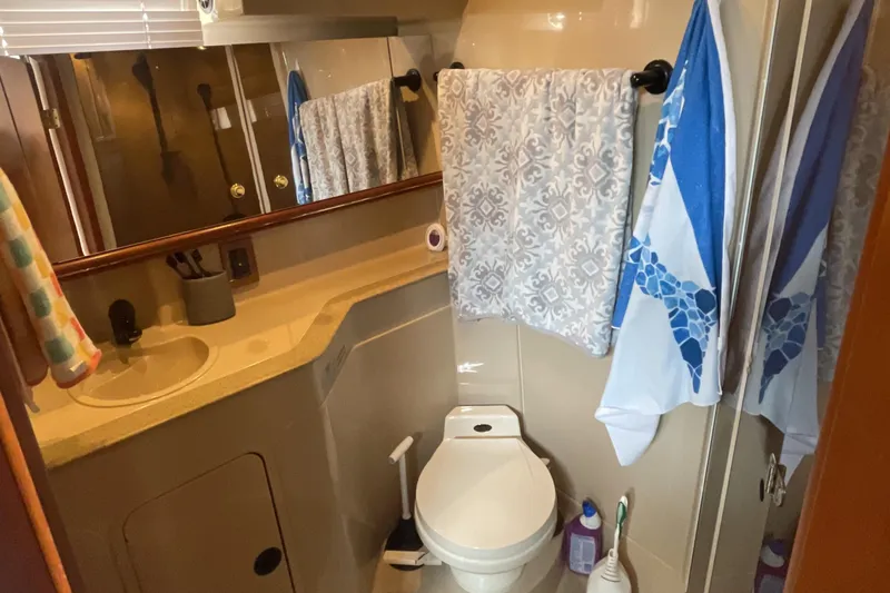 Slide: The Image of Bathroom interior of 2000 Cruisers Yachts 3870 Express with sink, toilet, and towels. - 43
