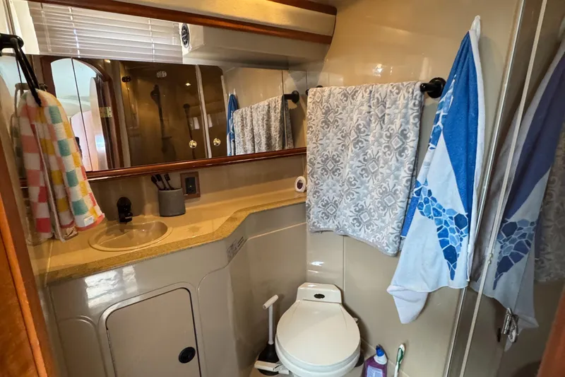 Slide: The Image of Bathroom of 2000 Cruisers Yachts 3870 Express with sink, toilet, and towels. - 44
