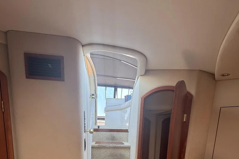Slide: The Image of Interior view of 2000 Cruisers Yachts 3870 Express, showing stairs and cabin entrance. - 48