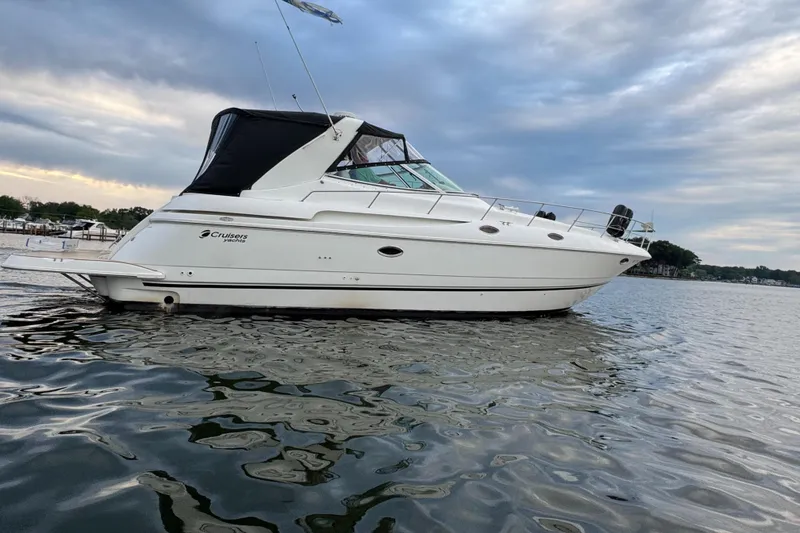 Slide: The Image of 2000 Cruisers Yachts 3870 Express on calm water under cloudy sky. - 5