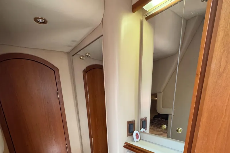 Slide: The Image of Interior of 2000 Cruisers Yachts 3870 Express with wooden door and mirrored cabinet. - 50