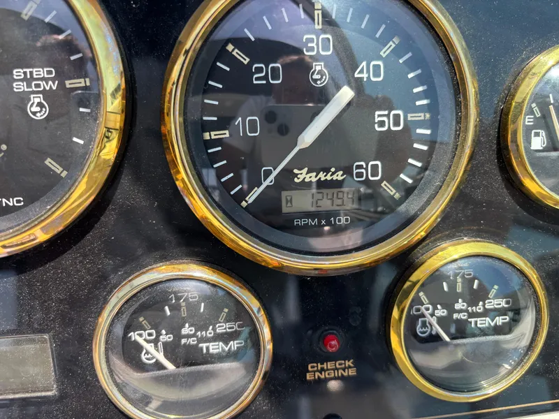 Slide: The Image of Close-up of 2000 Cruisers Yachts 3870 Express dashboard gauges, showing RPM and temperature. - 63
